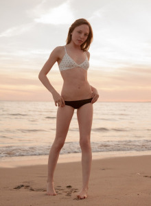 Teen has fun at the beach in the evening